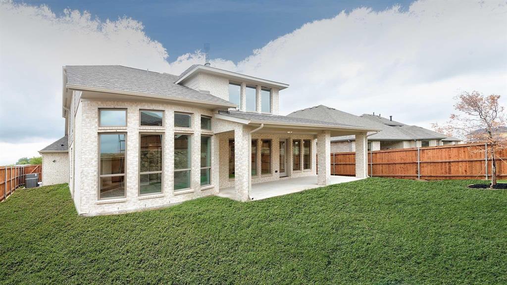 4237 Capstone Road Midlothian, TX 76065 - Photo 21 of 25 Expansive backyard with a manicured lawn, full privacy fencing, covered patio, and large windows