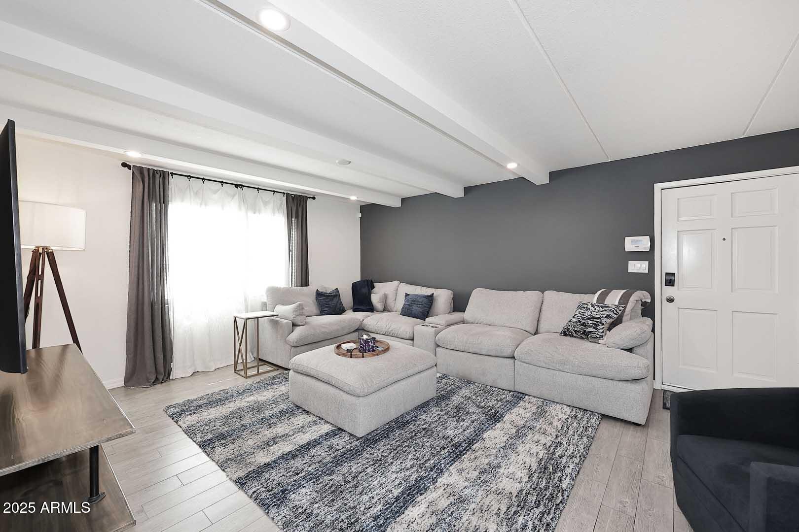 a living room with furniture and a rug