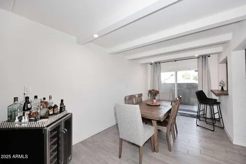 a dining room with furniture window and wooden floor