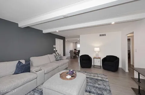 a living room with furniture and a mirror