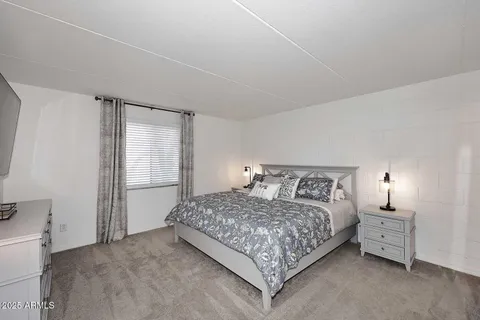 a bedroom with a bed and a night stand