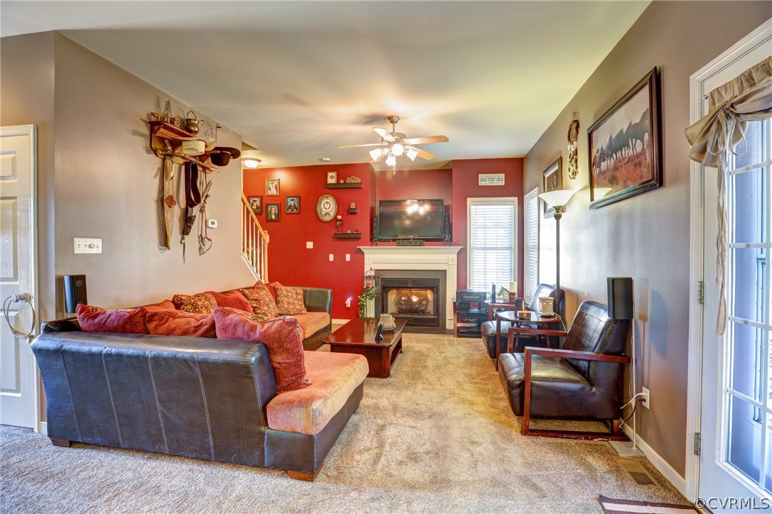 15855 Sandwave Road Chester, VA 23831 - Photo 16 of 42 a living room with furniture fireplace and a chandelier