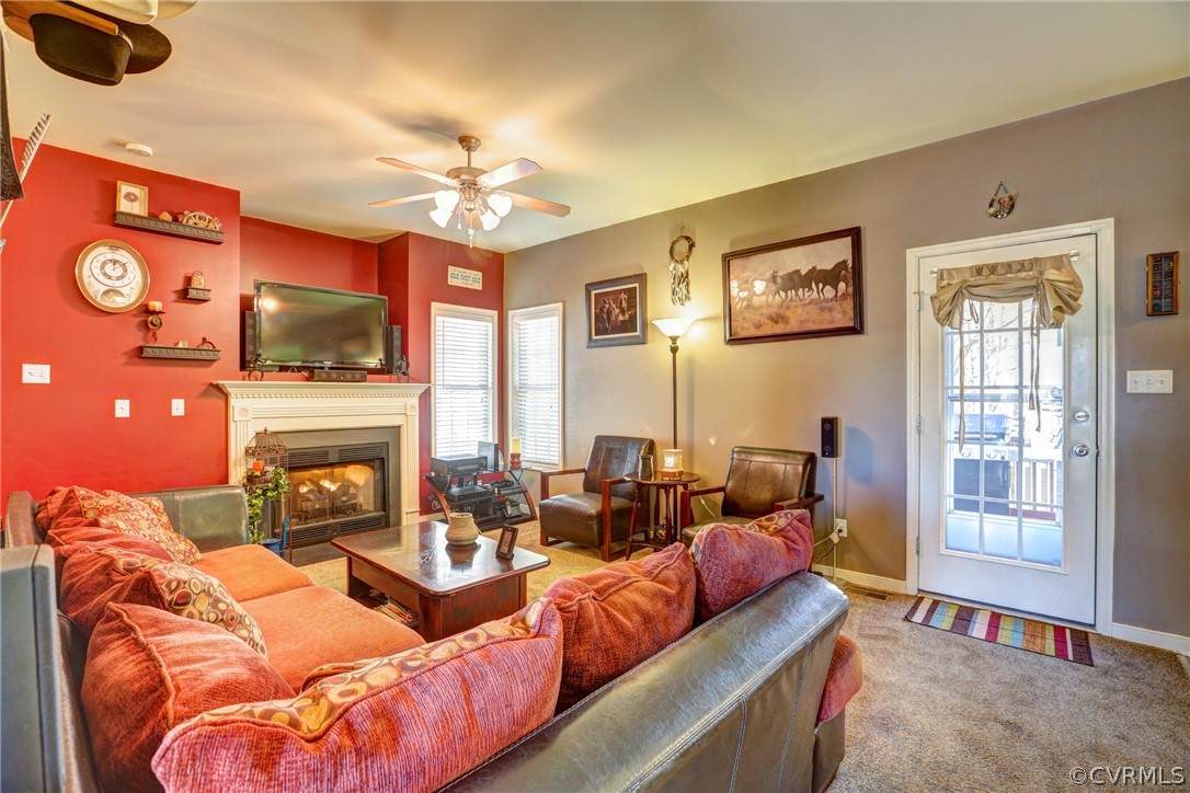 15855 Sandwave Road Chester, VA 23831 - Photo 17 of 42 a living room with furniture a fireplace and a flat screen tv