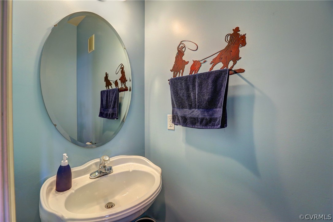 15855 Sandwave Road Chester, VA 23831 - Photo 20 of 42 a bathroom with a sink and mirror