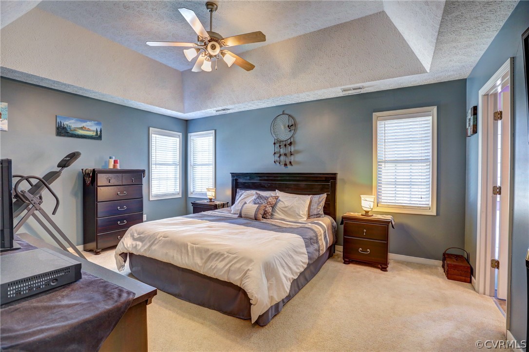 15855 Sandwave Road Chester, VA 23831 - Photo 21 of 42 a bedroom with a bed and a chandelier