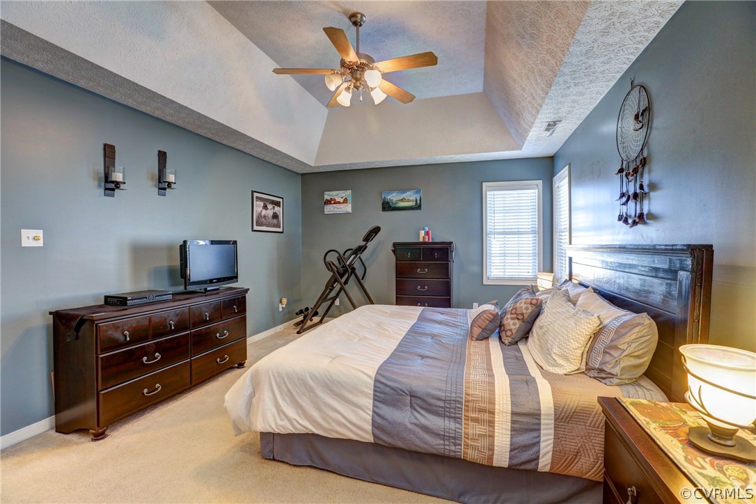 15855 Sandwave Road Chester, VA 23831 - Photo 23 of 42 a bedroom with a bed and a chandelier