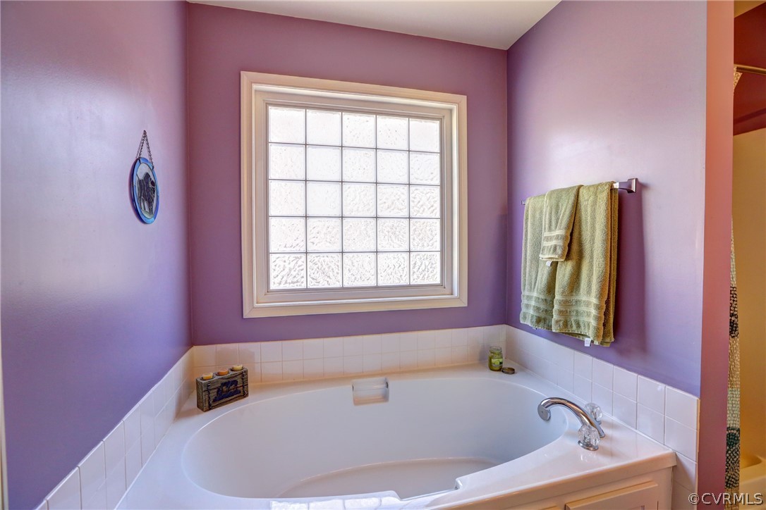 15855 Sandwave Road Chester, VA 23831 - Photo 25 of 42 a bath tub sitting in a bathroom next to a window