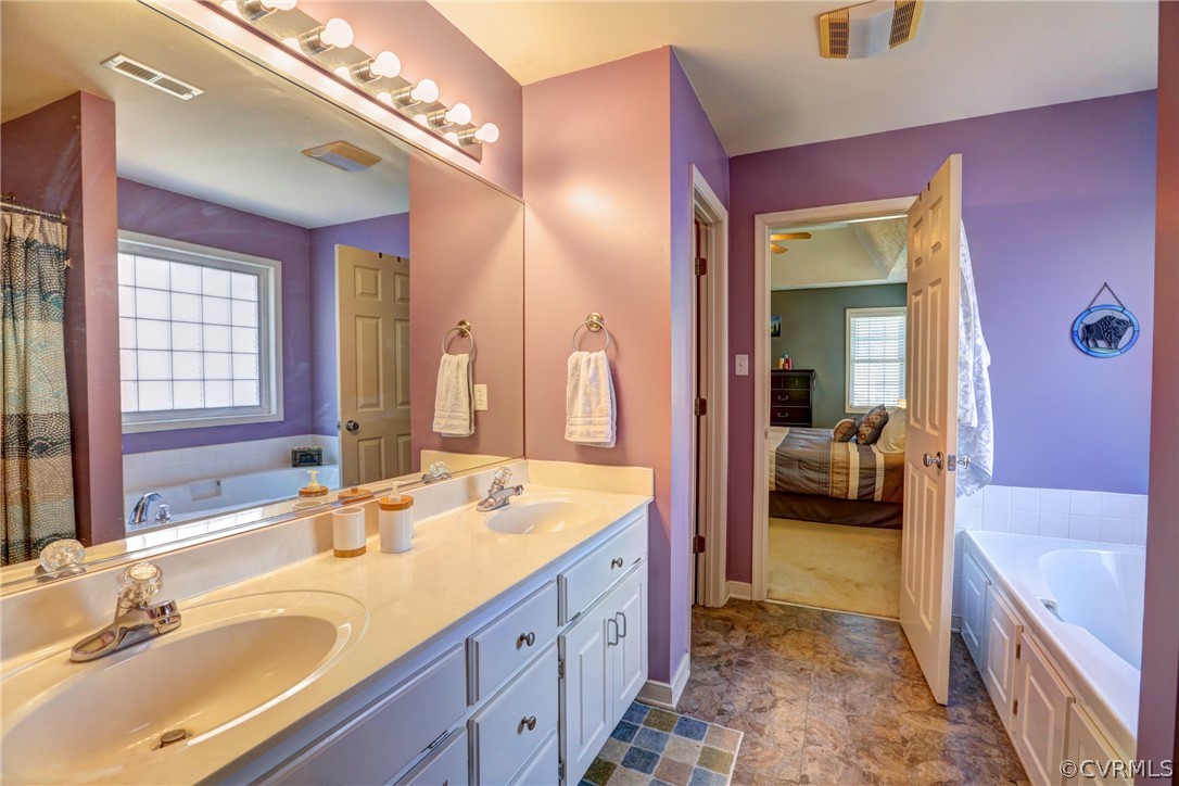 15855 Sandwave Road Chester, VA 23831 - Photo 26 of 42 a en suite spacious bathroom with a tub sink and mirror