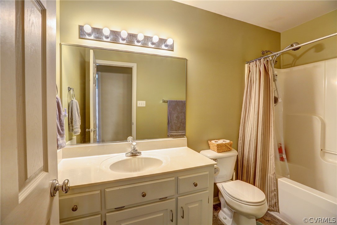 15855 Sandwave Road Chester, VA 23831 - Photo 28 of 42 a bathroom with a granite countertop sink toilet a mirror a vanity and shower