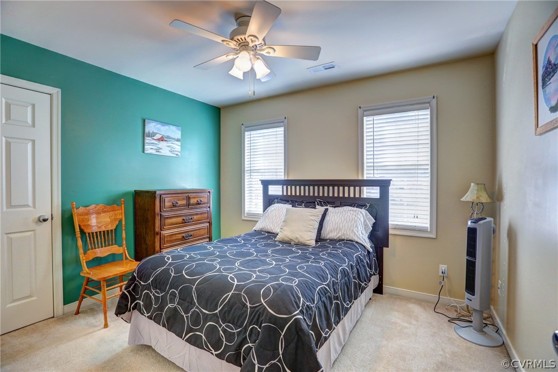 15855 Sandwave Road Chester, VA 23831 - Photo 32 of 42 a bedroom with a bed and a chandelier