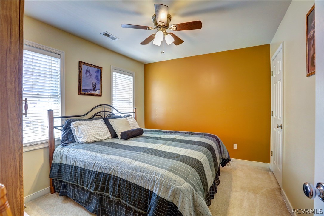 15855 Sandwave Road Chester, VA 23831 - Photo 33 of 42 a bedroom with a bed and a chandelier