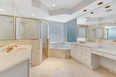 a bathroom with a tub sink and mirror