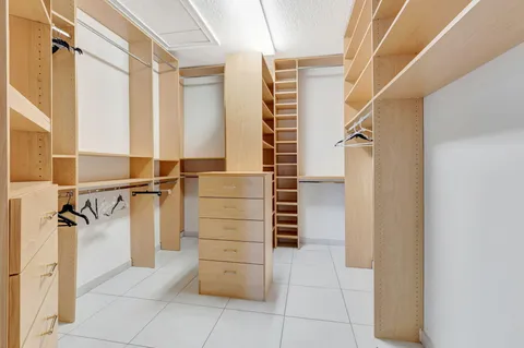 a view of walk in closet and stairs