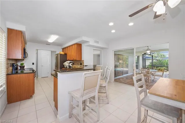 a kitchen with stainless steel appliances kitchen island granite countertop a sink and cabinets