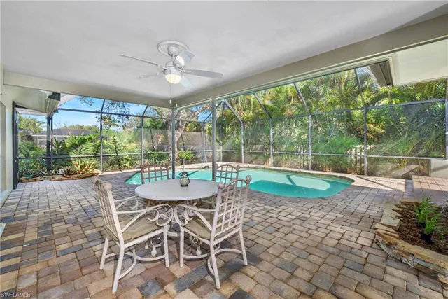 a view of a dining room with furniture large windows and wooden floor