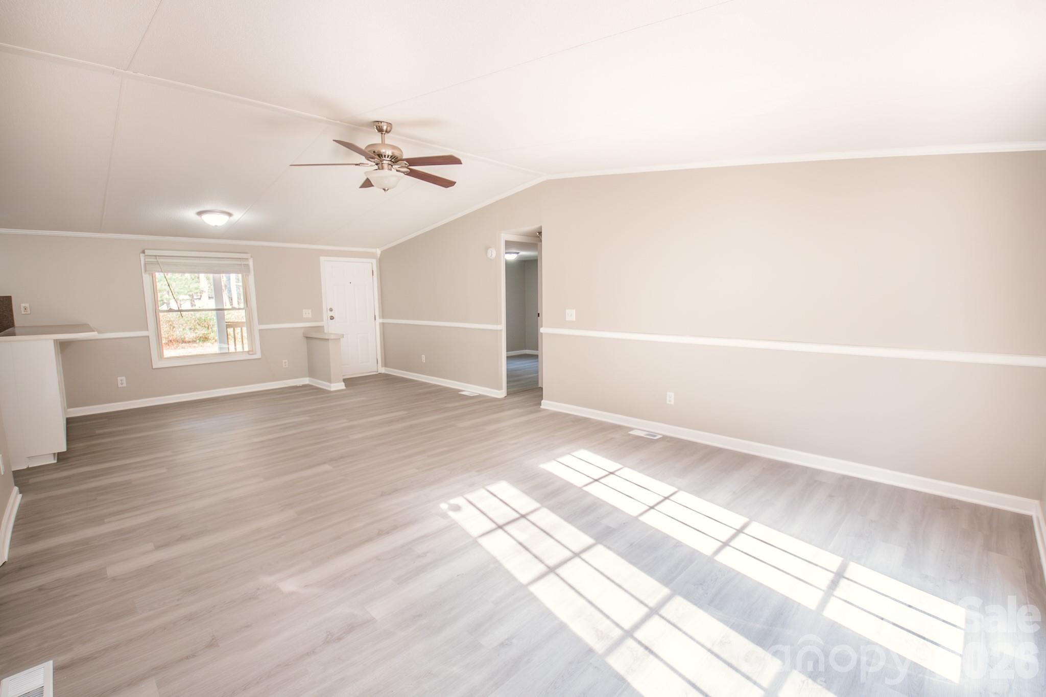 44082 Harper Hearne Road New London, NC 28127 - Photo 13 of 38 a view of empty room with wooden floor and fan