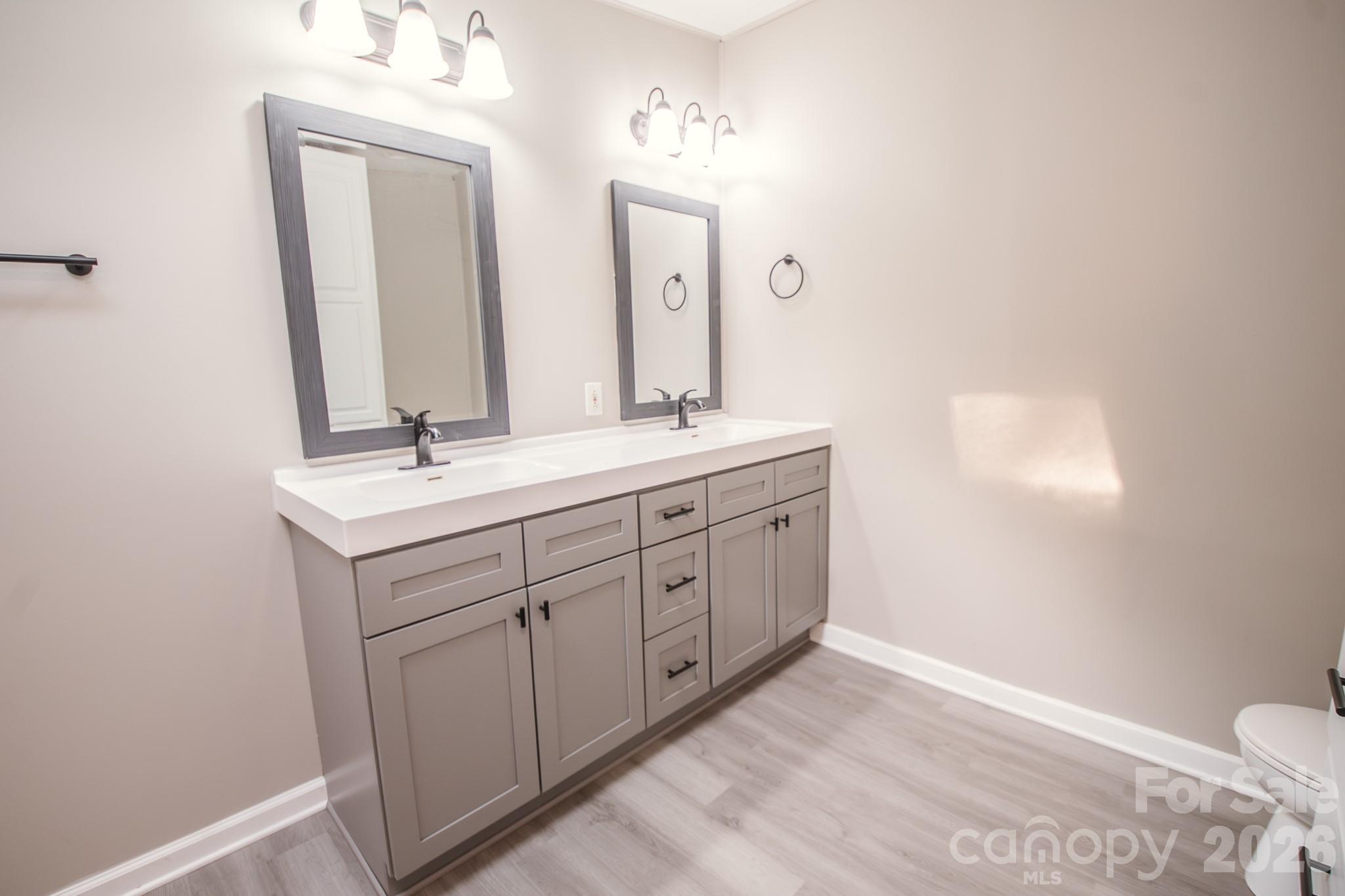 44082 Harper Hearne Road New London, NC 28127 - Photo 15 of 38 a spacious bathroom with a double vanity sink and a mirror