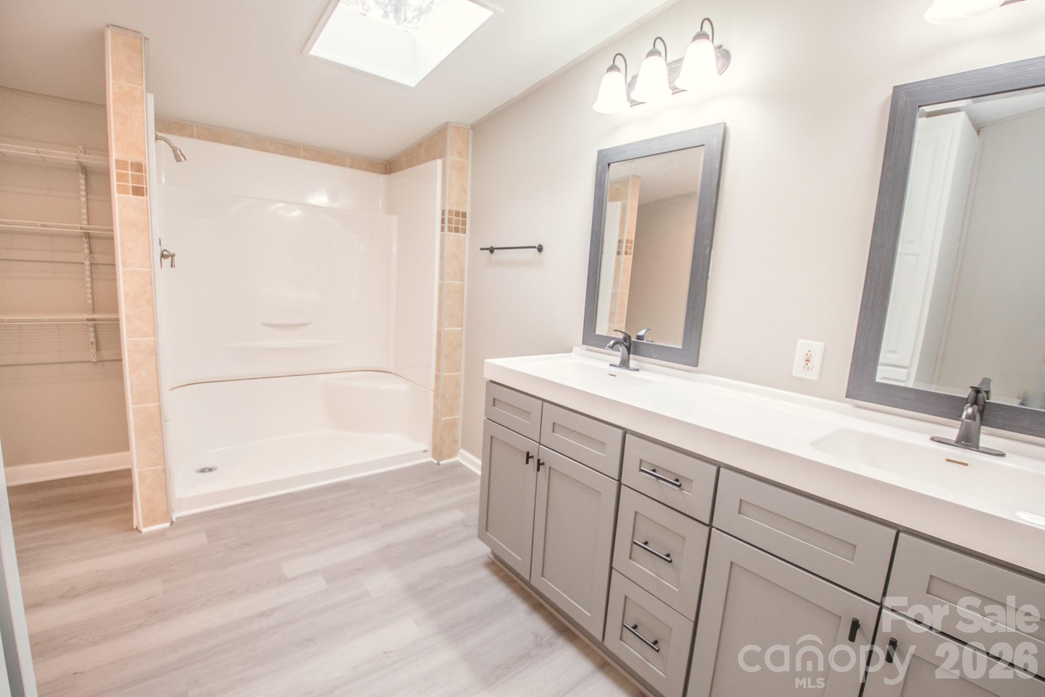 44082 Harper Hearne Road New London, NC 28127 - Photo 16 of 38 a bathroom with double vanity sink and a mirror