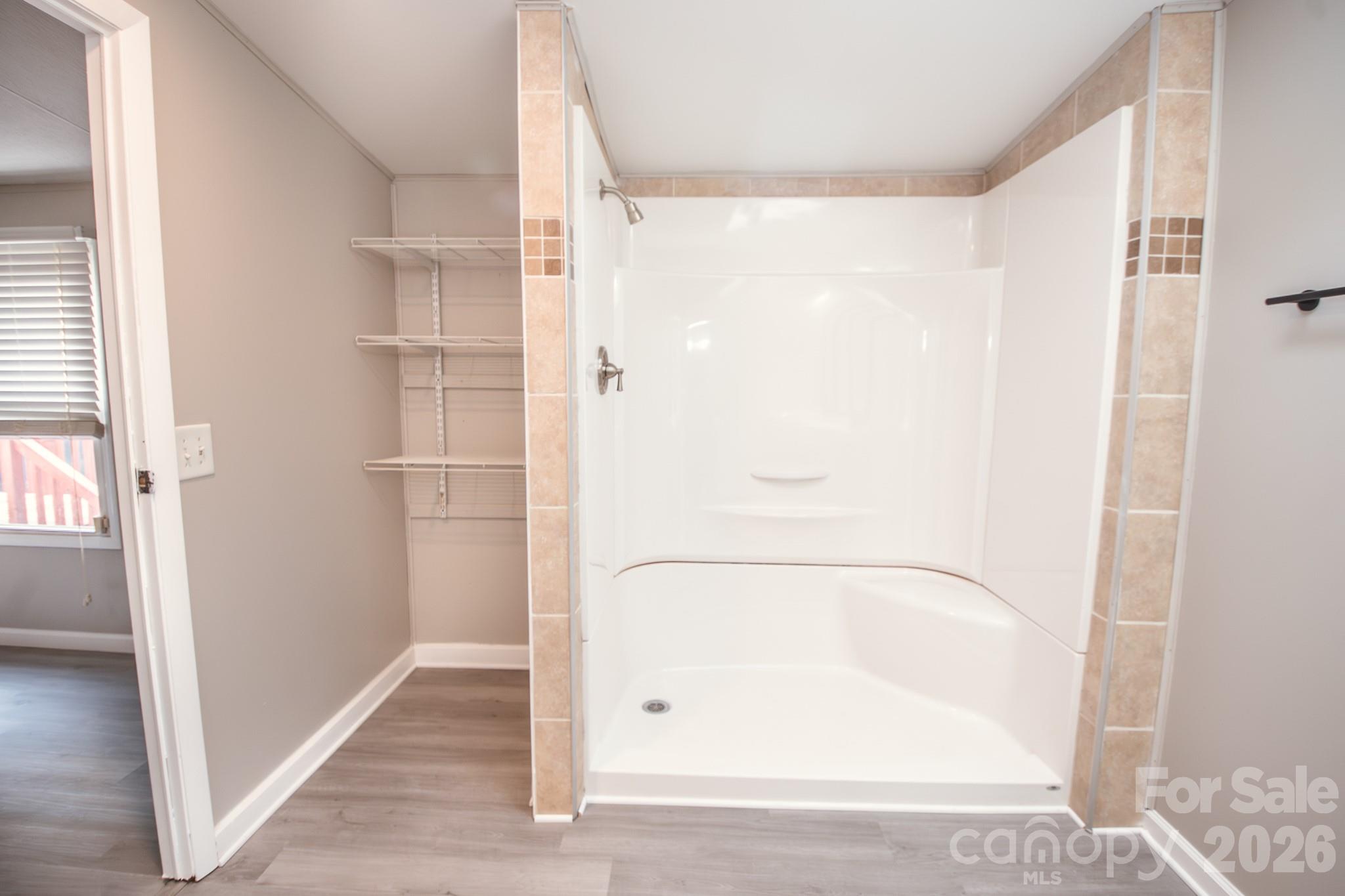44082 Harper Hearne Road New London, NC 28127 - Photo 18 of 38 a bathroom with a glass shower door