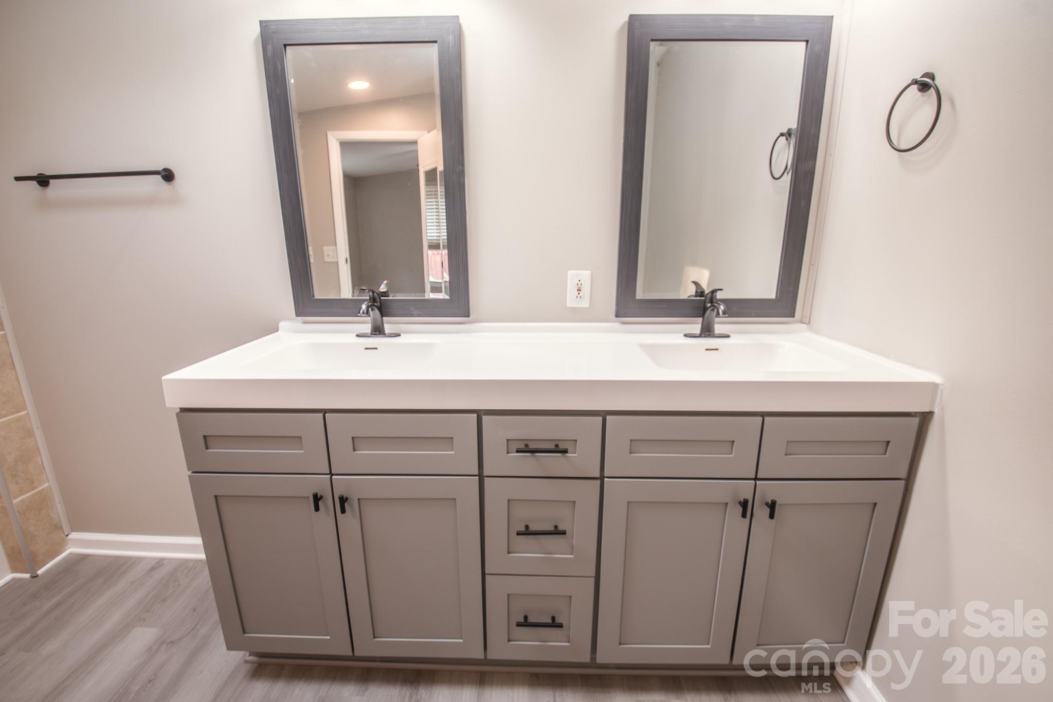 44082 Harper Hearne Road New London, NC 28127 - Photo 19 of 38 a bathroom with a double vanity sink and a mirror