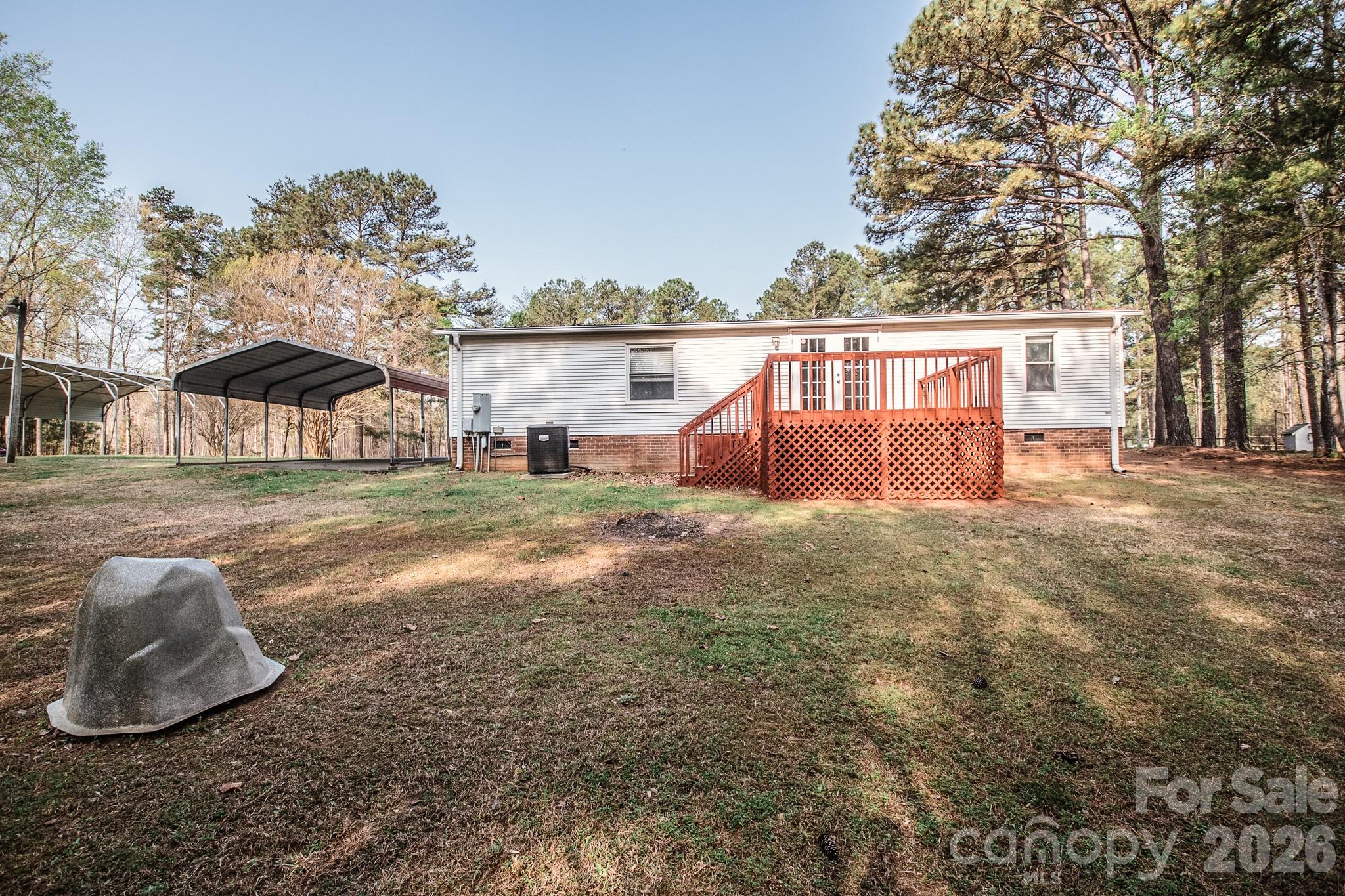 44082 Harper Hearne Road New London, NC 28127 - Photo 33 of 38 a backyard of a house with table and chairs