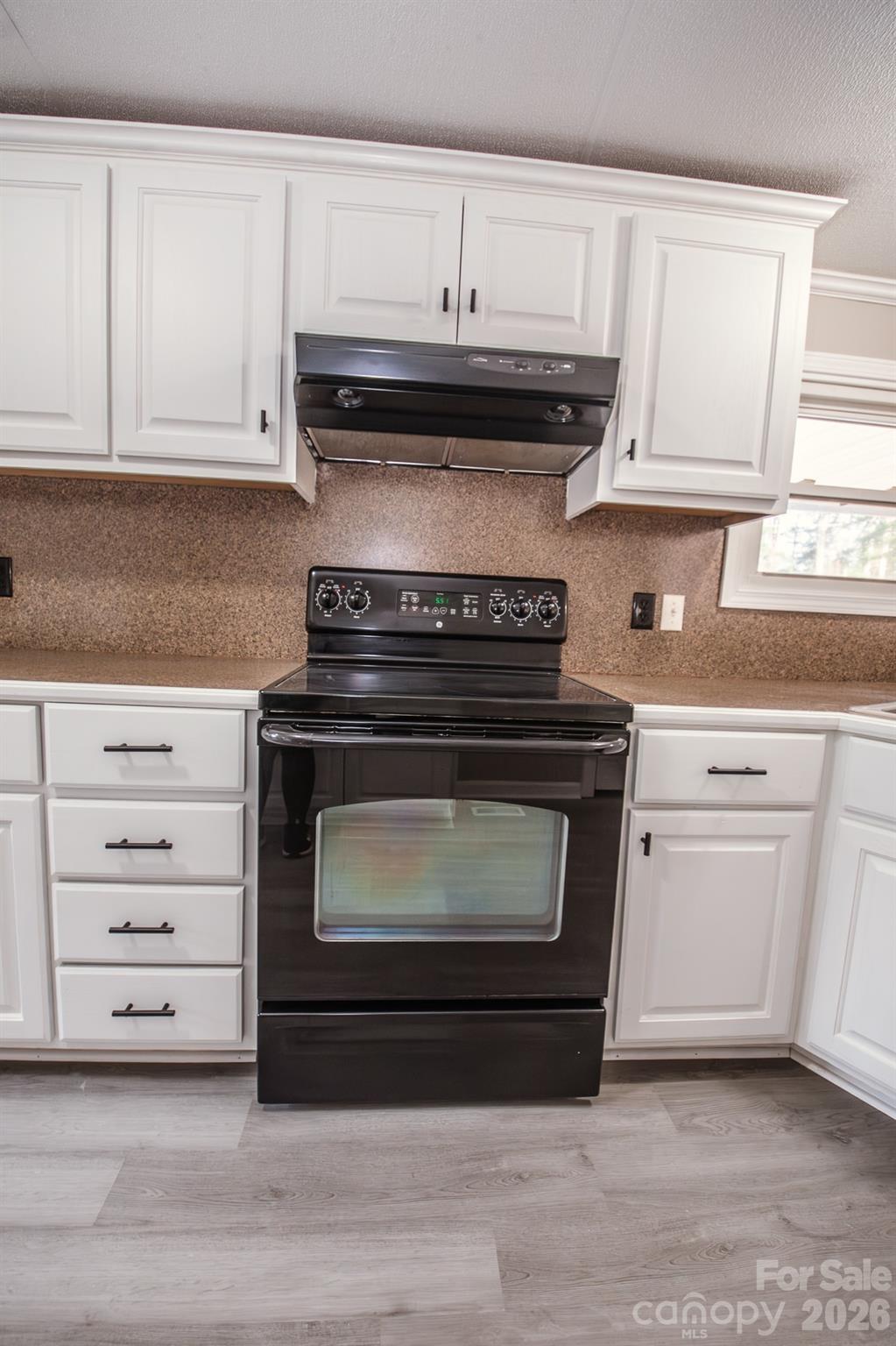 44082 Harper Hearne Road New London, NC 28127 - Photo 6 of 38 a stove top oven sitting inside of a kitchen