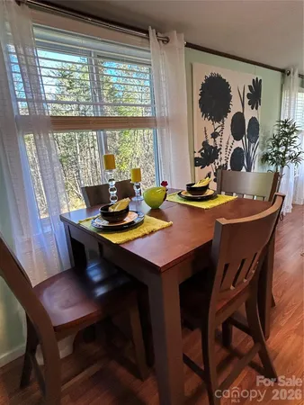 a view of a dining room with furniture and window