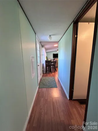 a view of a hallway view with wooden floor and furniture