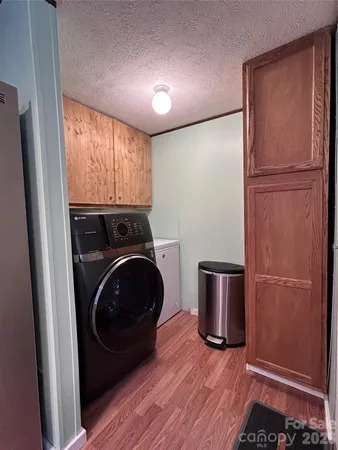 a view of a storage and utility room with washer and dryer