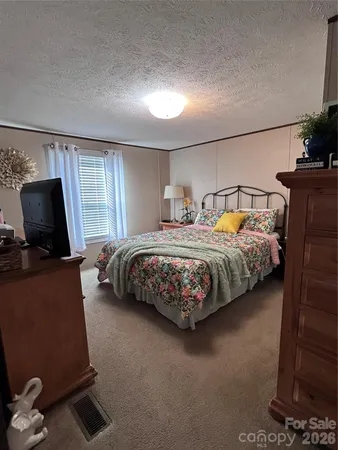 a bedroom with bed and window