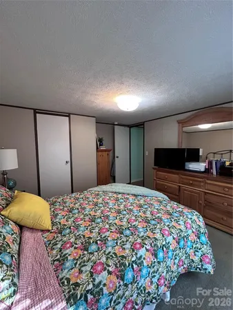 a large bedroom with a bed and a television in it