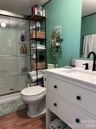 a bathroom with a sink a toilet and shower