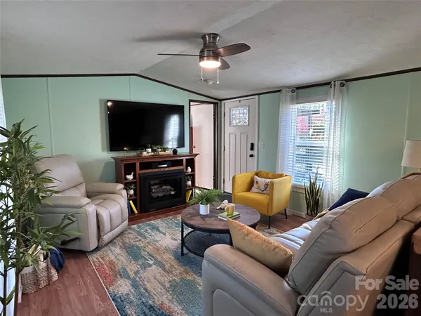 a living room with furniture and a flat screen tv
