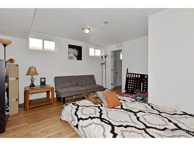 a bedroom with furniture and a wooden floor