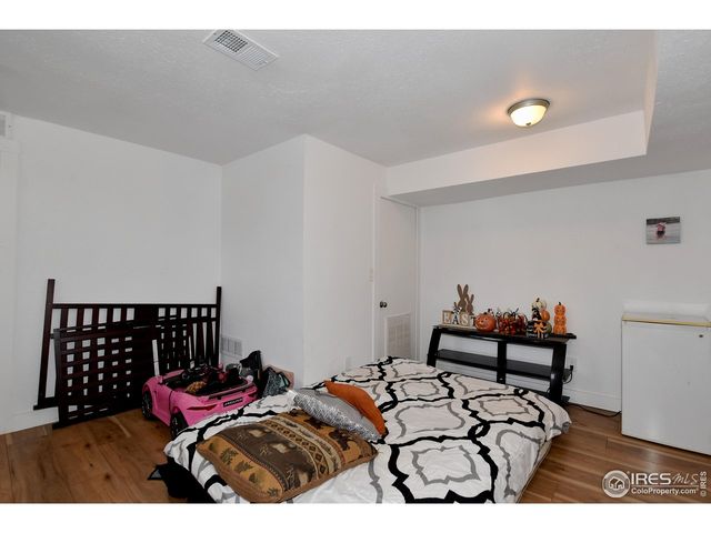 a bedroom with furniture and wooden floor