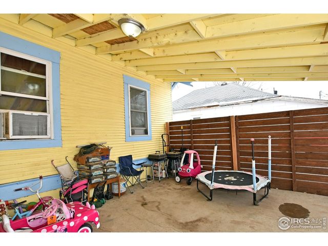 a view of a patio with table and chairs and potted plants