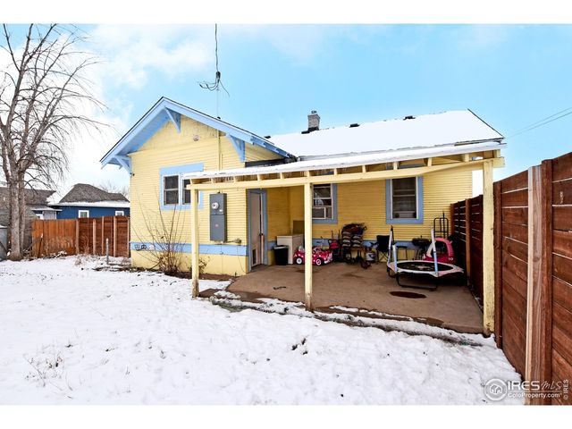 a front view of a house with a yard covered in snow
