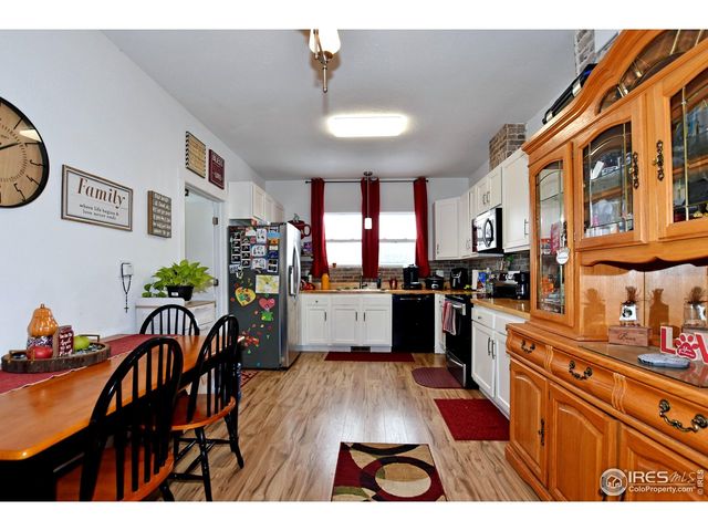 a kitchen view of a dining table chairs and entryway
