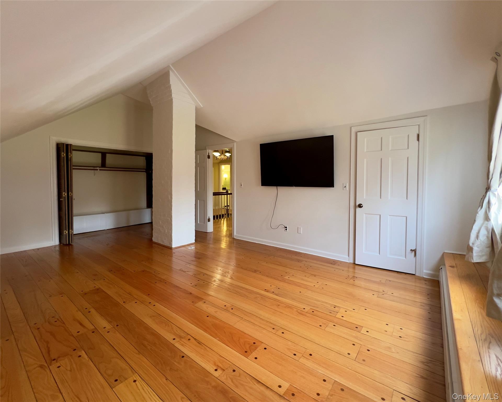 85 Washington Road Carmel, NY 10512 - Photo 14 of 30 a view of a livingroom with wooden floor and a flat screen tv