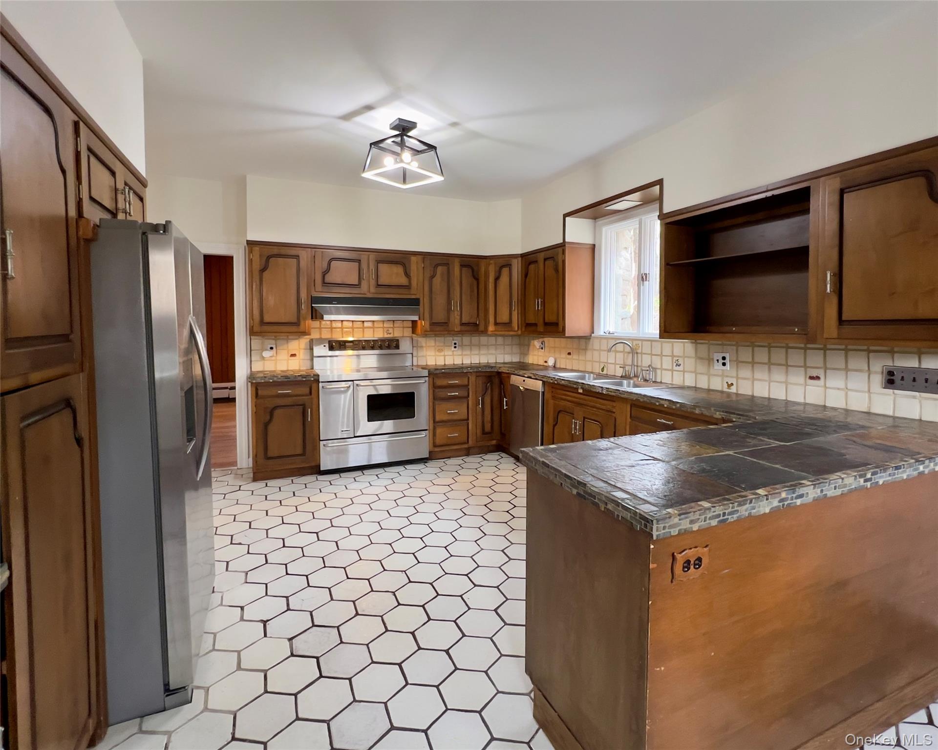 85 Washington Road Carmel, NY 10512 - Photo 3 of 30 a kitchen with stainless steel appliances granite countertop a sink stove and refrigerator