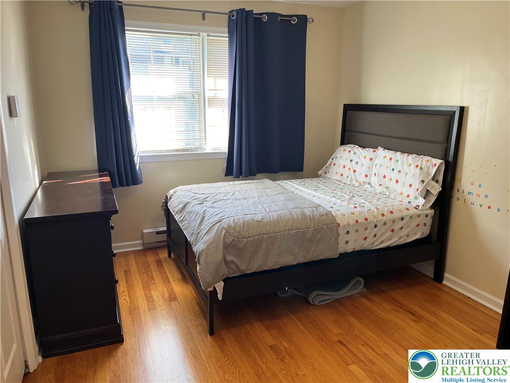 6221 Dove Drive Bethlehem, PA 18017 - Photo 25 of 38 Rich hardwood flooring complements the classic design of this cozy bedroom space.