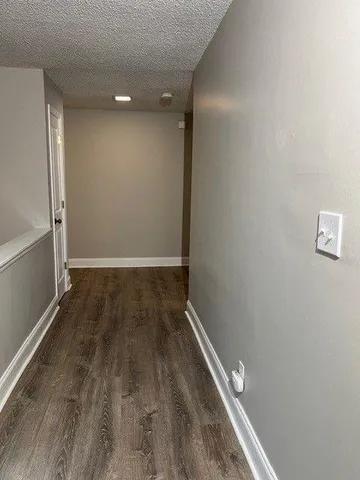 a view of room with wooden floor