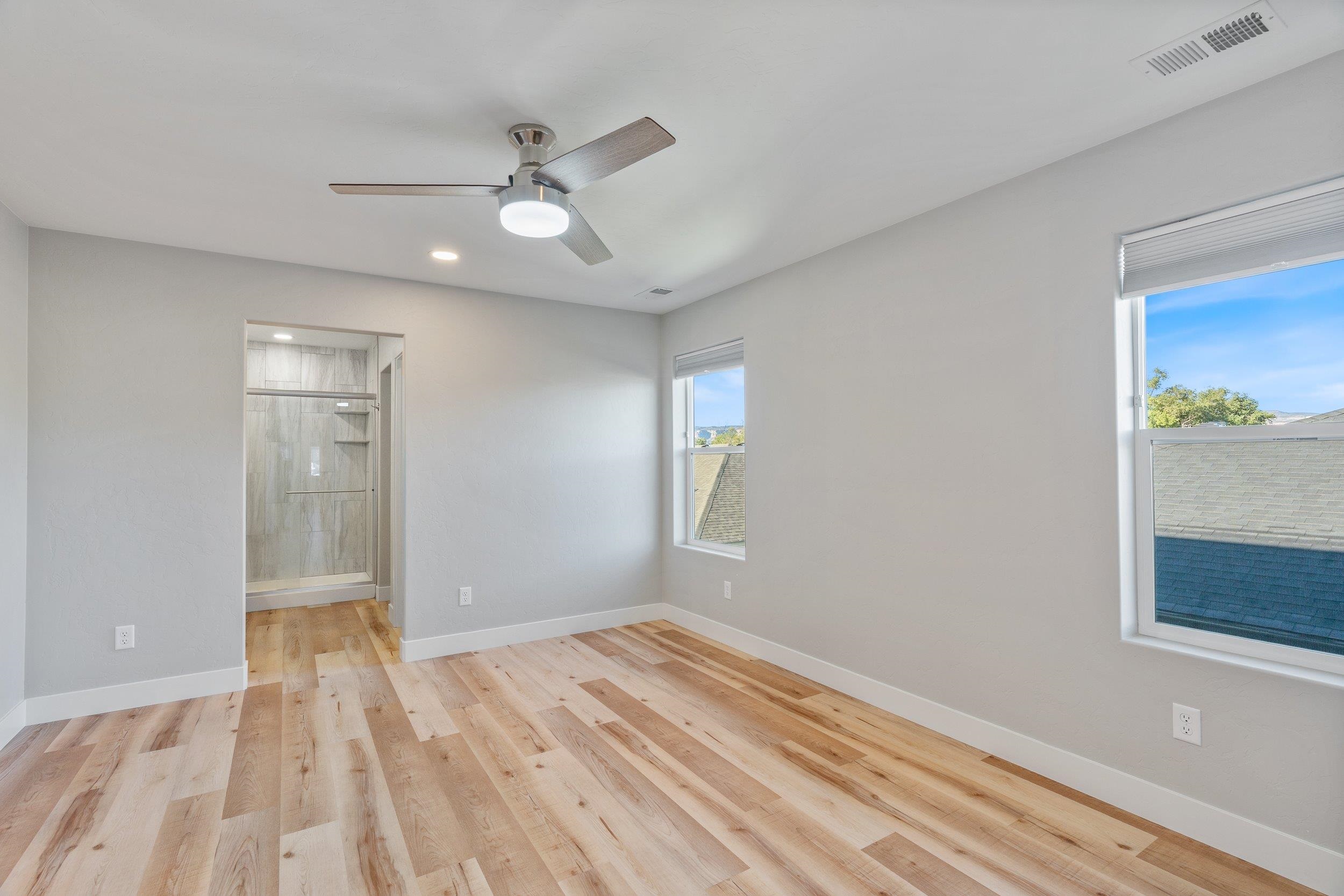 2453 Ross Road, Unit A Grand Junction, CO 81505 - Photo 13 of 27 a view of empty room with wooden floor and fan