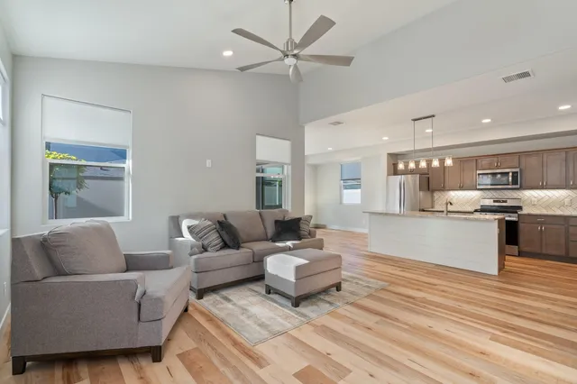 a living room with furniture and kitchen view