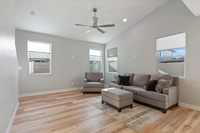 a living room with furniture and a wooden floor