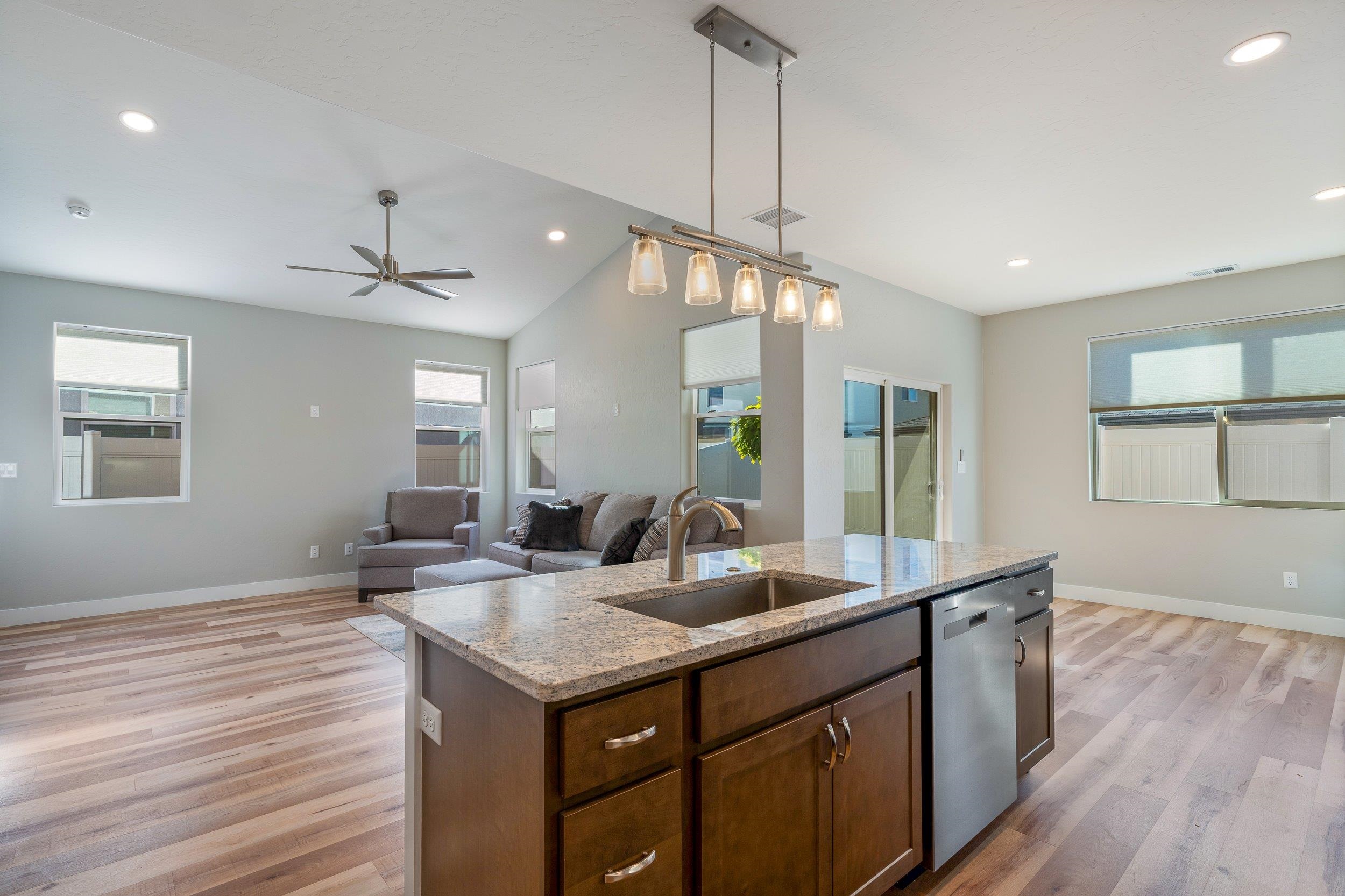 2453 Ross Road, Unit A Grand Junction, CO 81505 - Photo 5 of 27 a kitchen with granite countertop a sink cabinets and wooden floor