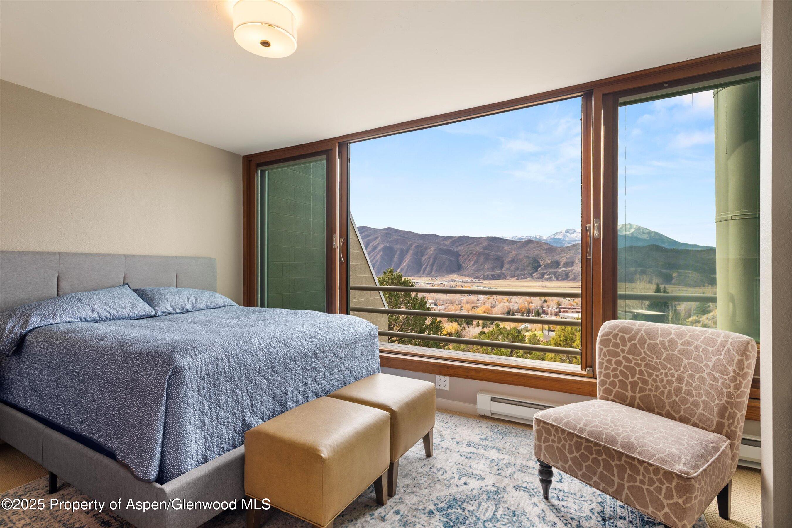 805 Pinon Drive, Unit 4 Basalt, CO 81621 - Photo 11 of 20 a bedroom with furniture and a large window