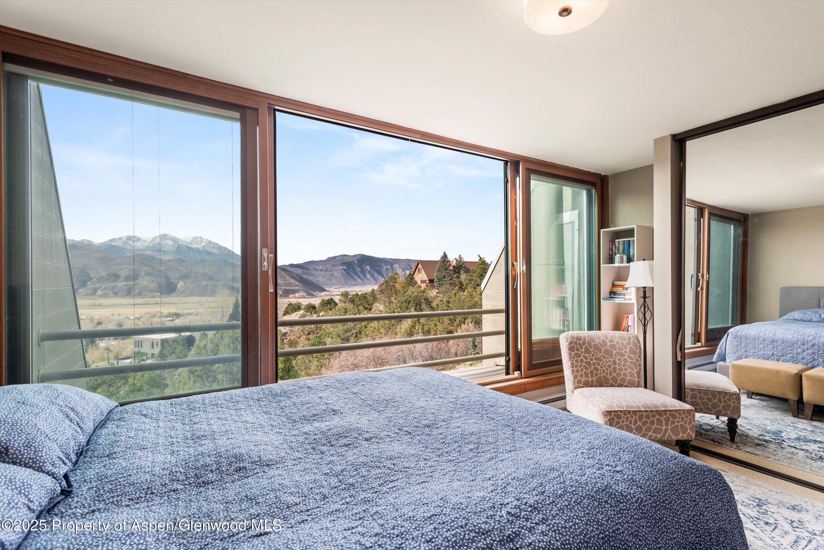 805 Pinon Drive, Unit 4 Basalt, CO 81621 - Photo 12 of 20 a bedroom with a large bed and a large window with outer view
