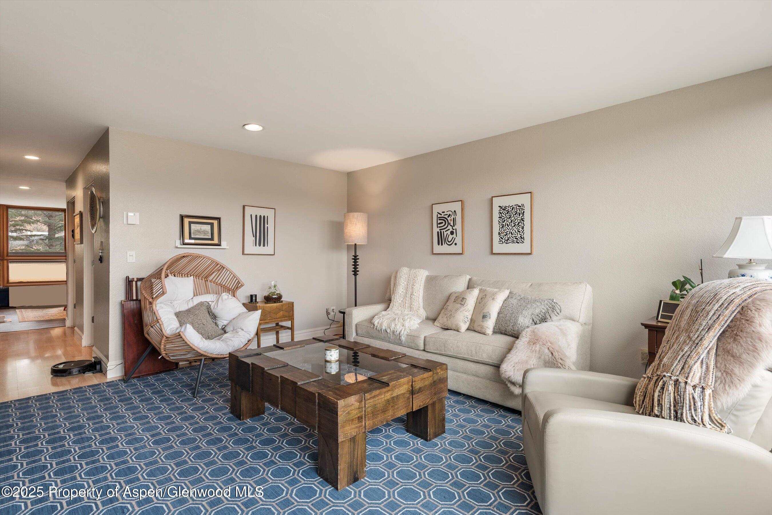 805 Pinon Drive, Unit 4 Basalt, CO 81621 - Photo 7 of 20 a living room with furniture a rug and wall painting