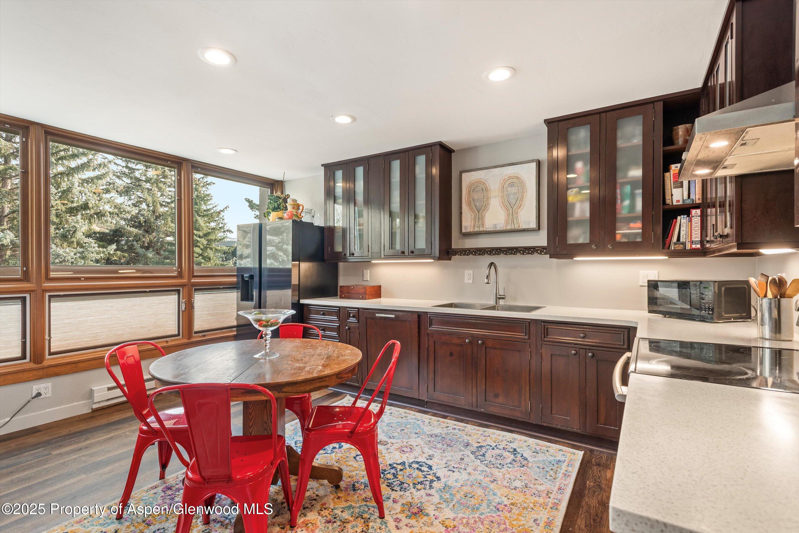 805 Pinon Drive, Unit 4 Basalt, CO 81621 - Photo 8 of 20 a kitchen with stainless steel appliances granite countertop a sink a stove a table and chairs